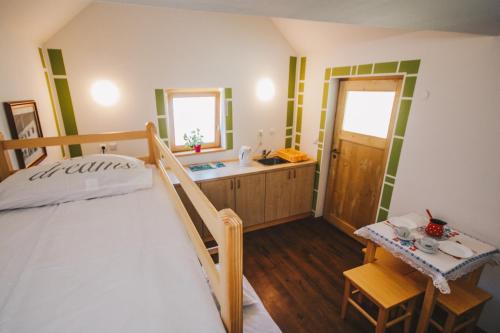 a bedroom with a bed and a bathroom with a sink at Počitniška hiška Pod Skalco in Kamnik