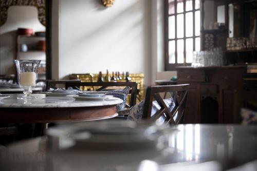 a dining room with a table and chairs with dishes on it at Seven Terraces in George Town