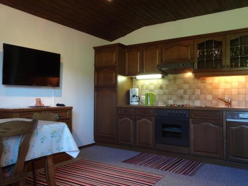 a kitchen with wooden cabinets and a stove top oven at Haus Erlbacher in Abtenau