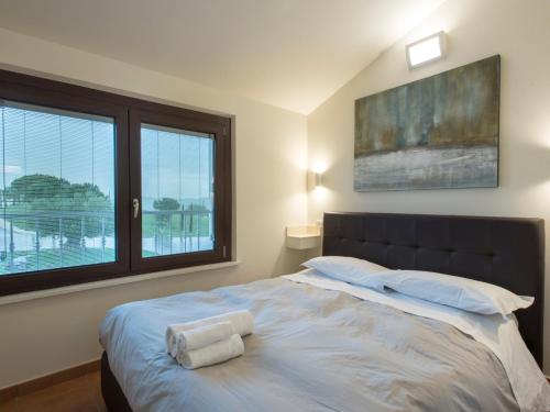 a bedroom with a large bed with two towels on it at Osteria dei Segreti in Appignano