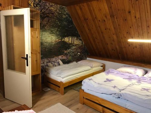 A bed or beds in a room at Chata Lucia