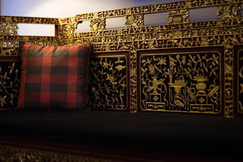 a bedroom with a bed with a black and gold wallpaper at Seven Terraces in George Town