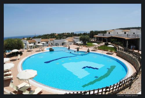 an overhead view of a large swimming pool at a resort at Hotel Resort Nuraghe Arvu in Cala Gonone