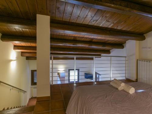 a bedroom with a bed and wooden beams at Osteria dei Segreti in Appignano