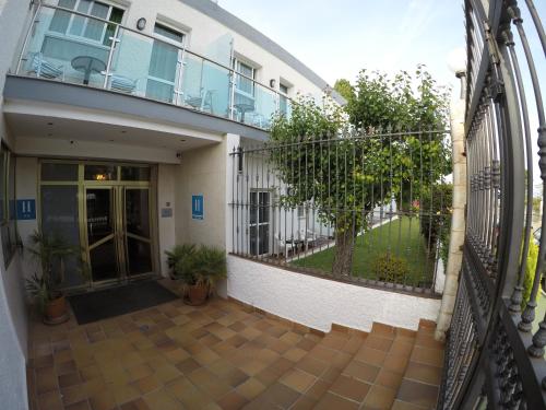 an external view of a building with a fence at Hotel Complejo Los Rosales in Torremolinos
