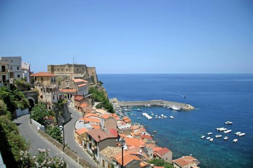 a town on a hill with boats in the water at Villa Paladino - B&B e Guest House in Scilla