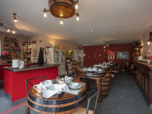 a restaurant with wooden tables and chairs and a bar at B&B AntiQua & Qook in Tongeren