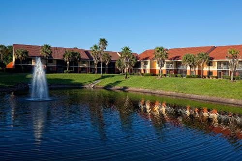 a fountain in the middle of a pond in front of a building at Westgate Vacation Villas Resort in Orlando