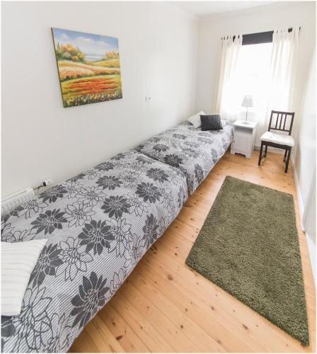 a large bed in a room with a window at Bergstaðastræti Apartment in Reykjavík
