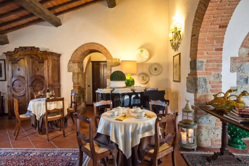 a dining room with tables and chairs in a building at Romantik Hotel Monteriggioni in Monteriggioni