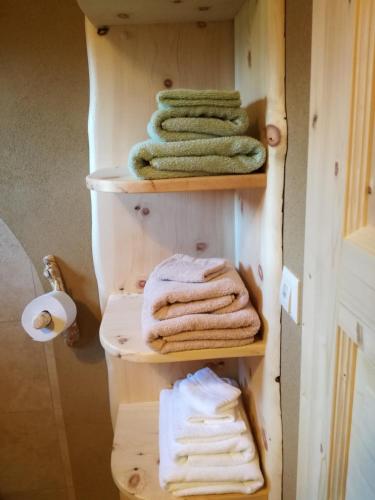 a towel rack with four towels in a bathroom at Haus der Sonne in Kötschach
