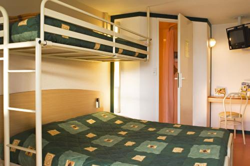 a bedroom with a bunk bed with a green quilt at Premiere Classe Dunkerque Loon Plage in Loon-Plage