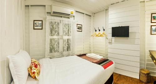 Postel nebo postele na pokoji v ubytování Baankachitpan Bangkok Hotel