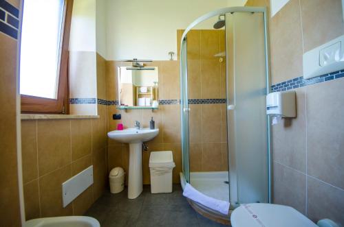 a bathroom with a shower and a sink and a toilet at Villa Margherita in Cefalù