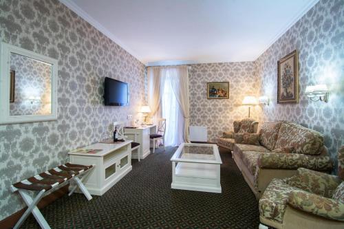 a living room with a couch and a table at Optima Collection Kamianets-Podilskyi in Kamianets-Podilskyi