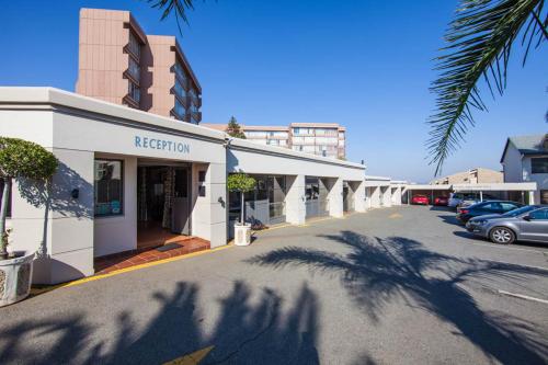 a street view of a building with a parking lot at Vetho 1 Apartments OR Tambo Airport in Johannesburg