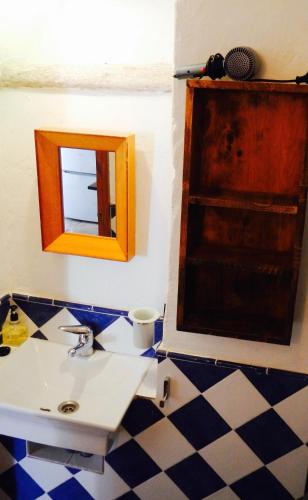 a bathroom with a sink and a mirror at Finca La Rana Verde in Cortes de la Frontera