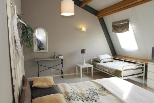 a bedroom with two beds and a window at de Hoeksesluis in Lekkerkerk