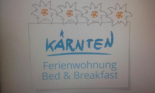 a sign for a bed and breakfast on a wall at Ferienhaus Melita in Bleiburg