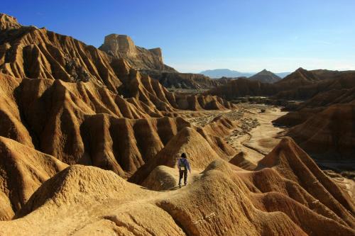 a man walking through the desert at Apartamentos Uncastillo in Uncastillo