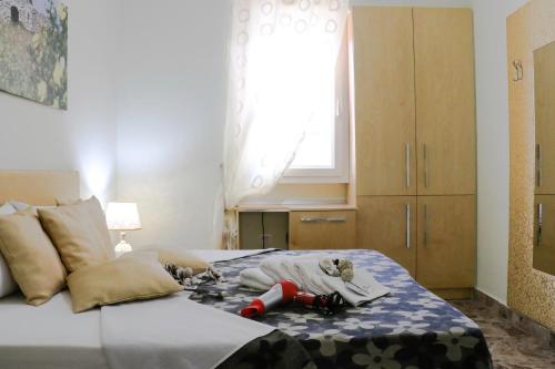 a bedroom with a bed with a window and bottles on it at B&B Vacanze Salento in Torre San Giovanni Ugento