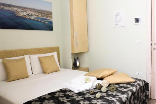 a bedroom with a large white bed with two pillows at B&B Vacanze Salento in Torre San Giovanni Ugento