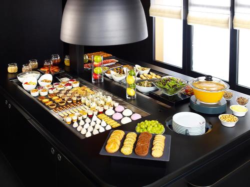 a buffet with many different types of food on a table at Campanile Colmar - Parc des Expositions in Colmar