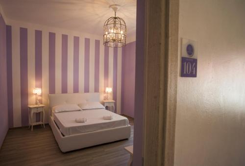 Ένα ή περισσότερα κρεβάτια σε δωμάτιο στο Les Suites Magnolia