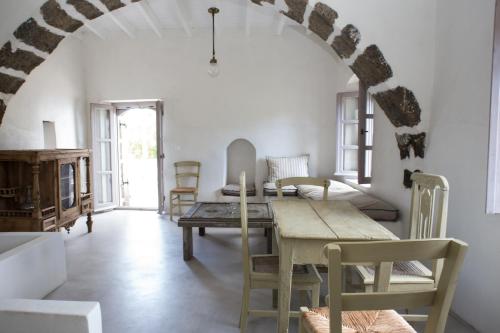 ein Esszimmer mit einem Tisch und Stühlen in der Unterkunft Kafka Stone House in Emporeiós