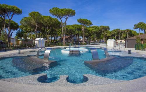 a swimming pool with two slides in a park at Camping Village Cavallino in Cavallino-Treporti