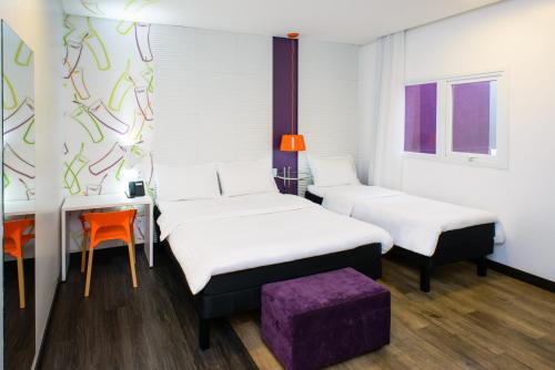 מיטה או מיטות בחדר ב-ibis Styles Ponta Pora
