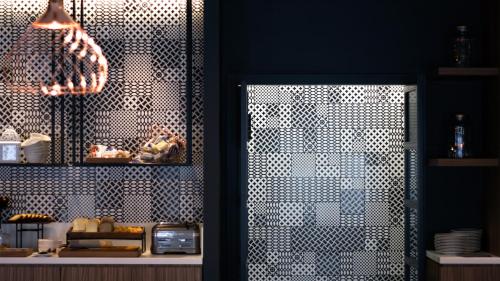 a restaurant with a metal latticed door in a room at G Hotel Pescara in Pescara