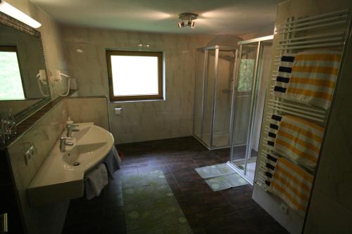 a bathroom with a sink and a shower at "Adamerhof" in Gerlosberg