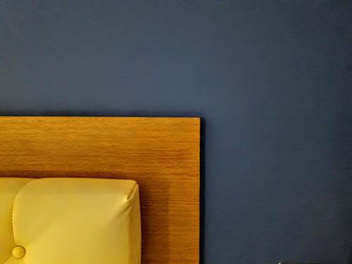 a close up of a piece of wood against a blue wall at Hospedería Santa Elena in San Carlos del Valle