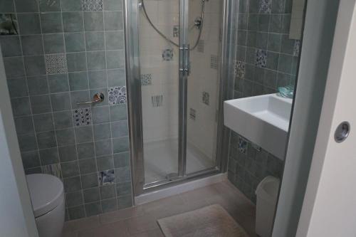 a bathroom with a shower and a toilet and a sink at Il Vicolo 48 in Pesaro