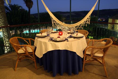 a table with a table cloth on a balcony with a tableablish at Solar de Chacim - Turismo de Habitação in Chacim
