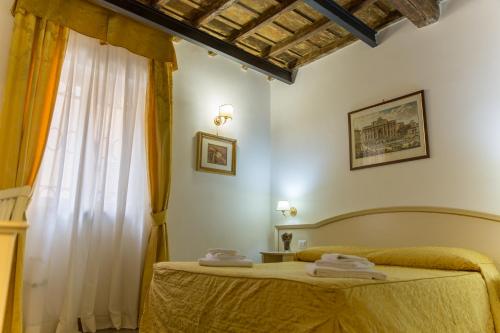 En eller flere senge i et værelse på Best Suites Pantheon