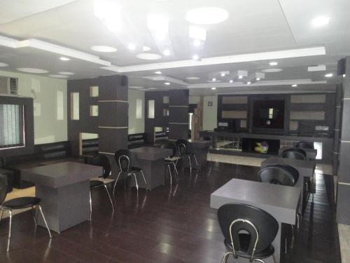 a restaurant with tables and chairs in a room at Hotel Green Valley in Guwahati