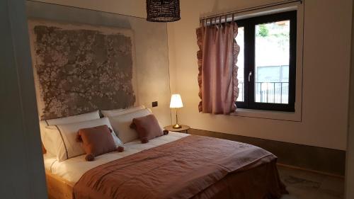 a bedroom with a large bed with a window at Rocca d'Anfo B&B-Apartments Lake View in Rocca dʼAnfo