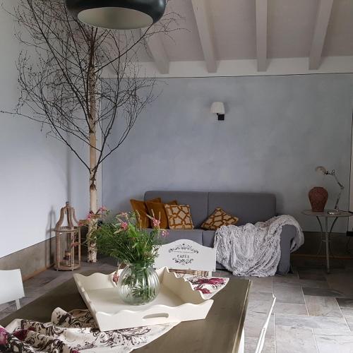 a living room with a couch and a table at Rocca d'Anfo B&B-Apartments Lake View in Rocca dʼAnfo