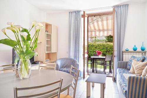a living room with a table and a couch at Residence Domaso in Domaso