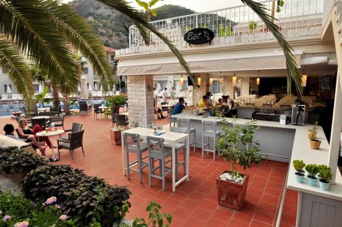a restaurant with people sitting at tables and a bar at The Blue Lagoon Deluxe Hotel in Oludeniz