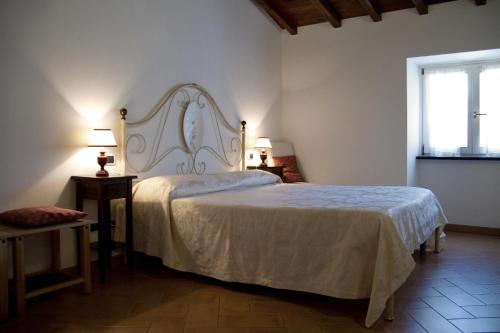 a bedroom with a bed and two tables and two lamps at L'Antica Pieve Bed & Breakfast in Levanto
