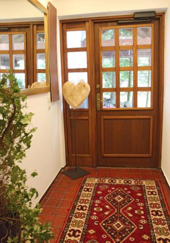 a heart hung on the door of a house at Hotel Adlerschanze in Schonwald im Schwarzwald