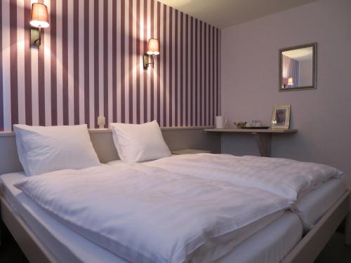 Tempat tidur dalam kamar di Golf Hotel Mergelhof