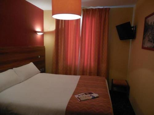 a bedroom with a bed and a red curtain at Residence Share Inn in Nice