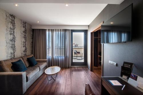 a living room with a couch and a table at Catalonia Plaza Catalunya in Barcelona