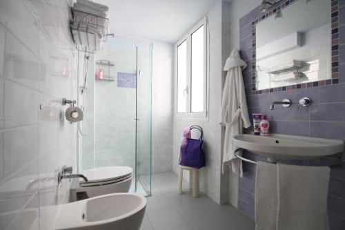 a bathroom with a sink and a toilet and a shower at Hotel Capri in Bellaria-Igea Marina