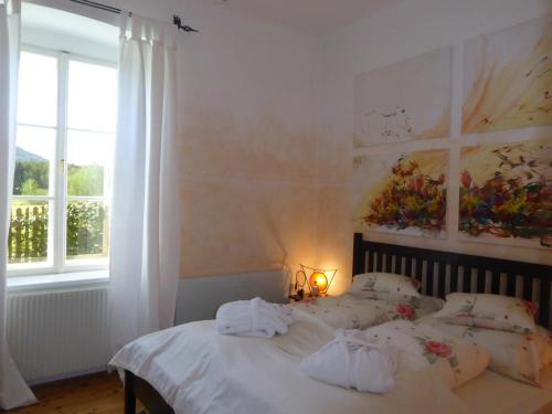 a bedroom with a bed with towels on it at Romantik-Villa LebensART in Reichenfels