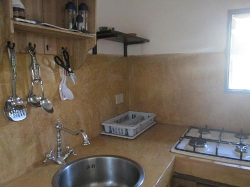 a kitchen counter top with a sink and a sink at Dammusi La Favarotta in Pantelleria
